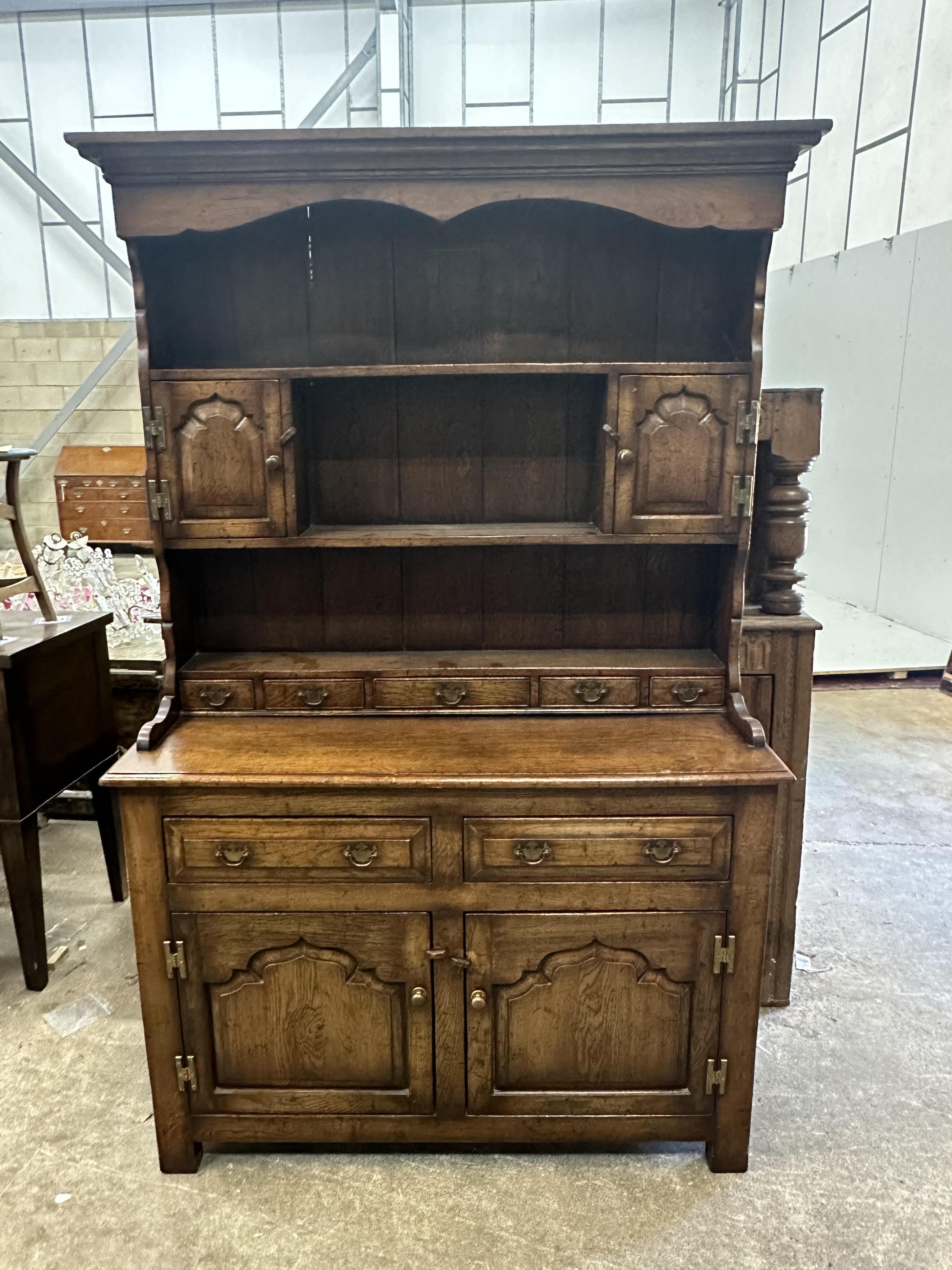 A small 18th century style oak dresser with boarded rack, width 118cm, depth 44cm, height 188cm.